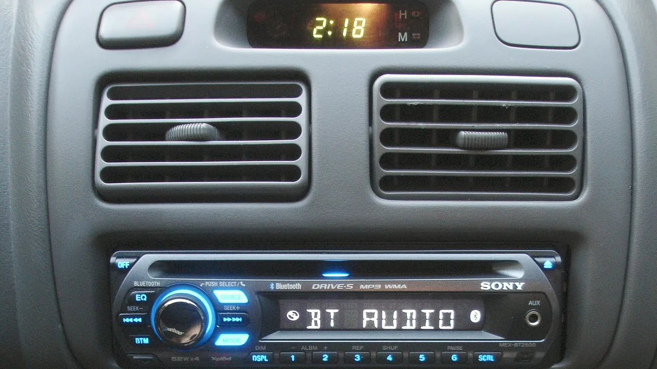 Car dashboard with MEX-BT2500 head unit and BCT-15 radio scanner installed and illuminated