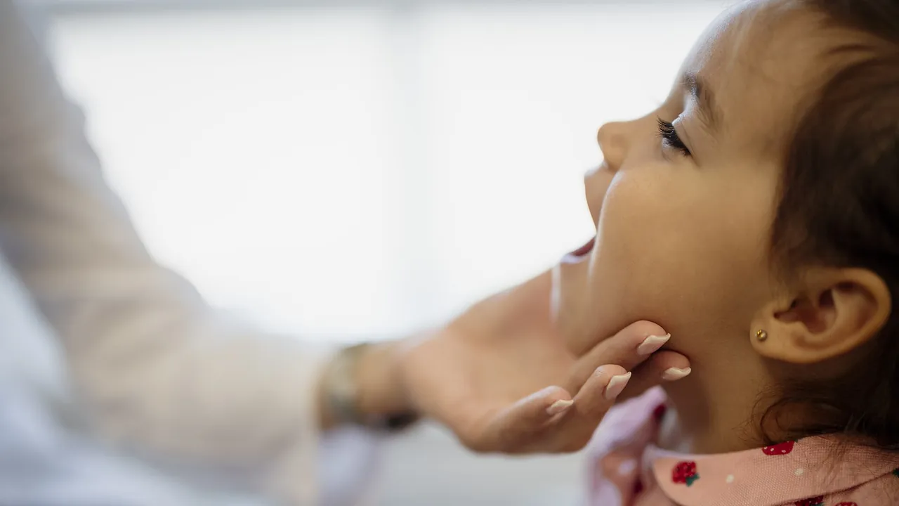 Child during dental checkup in clinic with dentist examining teeth