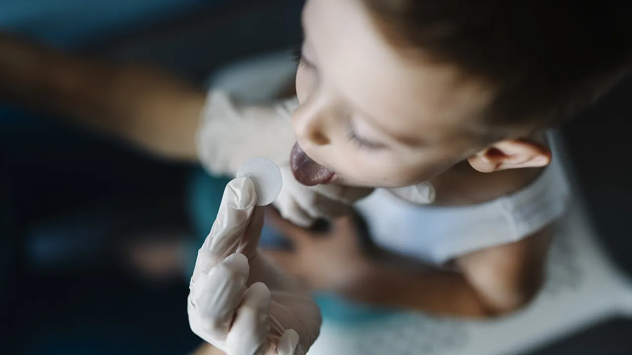 Child receives oral checkup from above