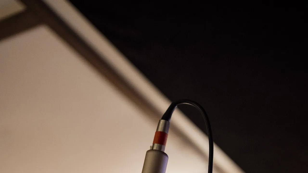 Close up view of a microphone set up in a recording studio