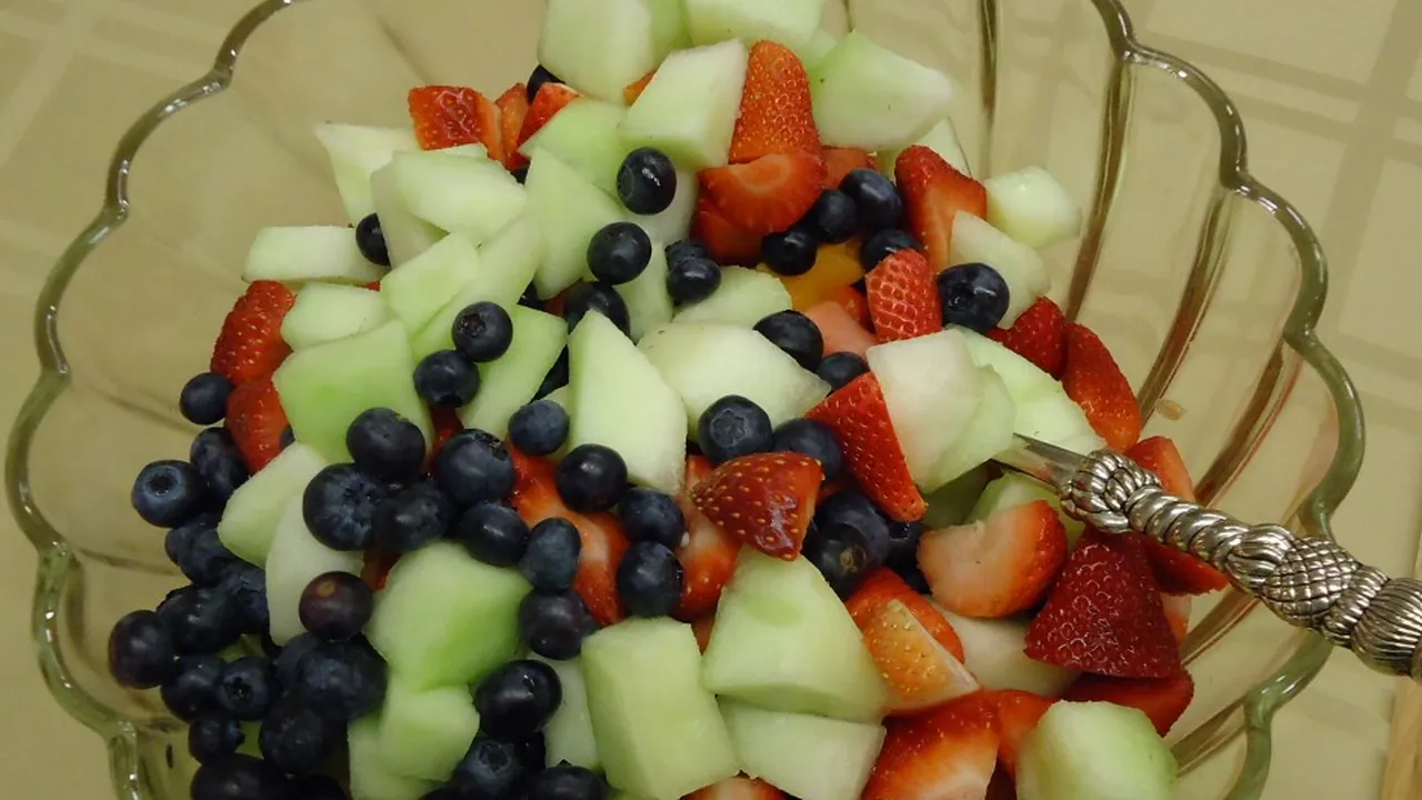 Honeydew melon and blueberries and strawberries in bowl