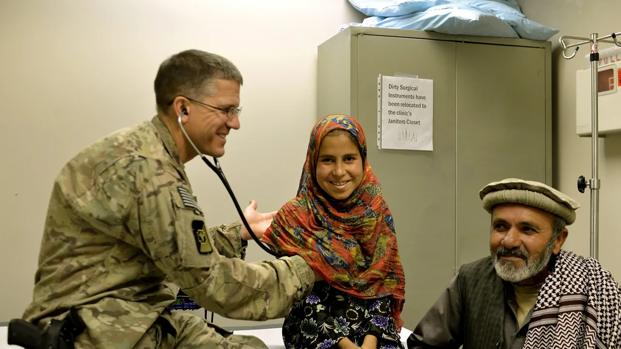 U.S. Air Force Lt. Col. David Jones, left, a pediatrician with the 455th Expeditionary Medical Group, examines an Afghan