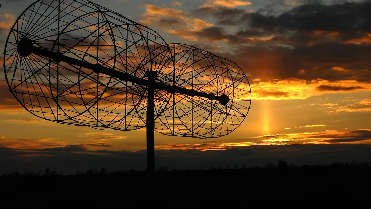 A dipole of UTR-2 radio telescope antenna array and sunset with light pillar